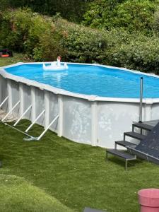 a small swimming pool with avisor around it at Villa Bretagne 5 chambres doubles 3 SDB in Plérin