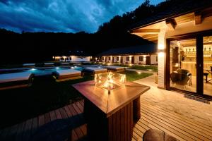 a patio with a table with lights on it at Hunter's Mansion - Transylvania in Gorgan +53 photos