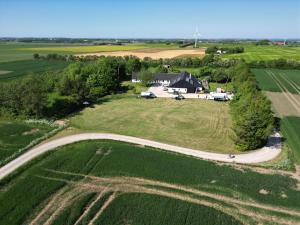 an aerial view of a large field with a house at Alpaca Bed & Fields in Snedsted