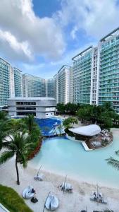 a large swimming pool in front of a large building at Azure Urban Resort Residences St Tropez Tower Near SM Bicutan with Wave Pool in Manila