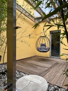 a patio with a swing on the side of a house at PaderCityLoft- lichtdurchflutet und privat mit Kamin-Dachterrasse-Sauna-Außendusche im Atrium in Paderborn