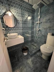 a bathroom with a toilet and a sink and a mirror at Ana L2 in Constanţa