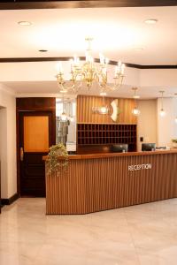 a hotel lobby with a reception desk and a chandelier at Galenia Boutique Hotel in Springbok