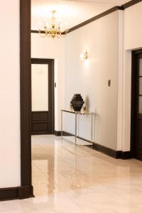 a hallway with a table and a black door at Galenia Boutique Hotel in Springbok +11 photos