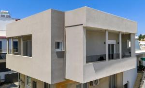 a facade of a building with large windows at Elia village in Kalithies +11 photos