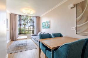 a living room with a couch and a table at Breakers Resort 316 Umhlanga in Durban