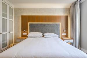a bedroom with a large bed with white sheets at Breakers Resort 316 Umhlanga in Durban +19 photos