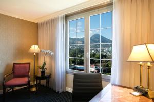 a room with a large window with a view of a mountain at Barceló San Salvador in San Salvador