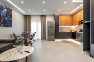 a kitchen and a living room with a table at Elia village in Kalithies