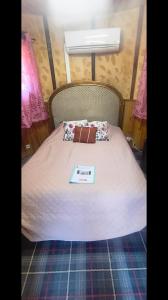 a bed with a book sitting on top of it at Chambre de la Tour 1 in Milhac +8 photos