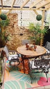 a wooden table and chairs on a patio at The Seaside Hideaway St Leonards in Hastings
