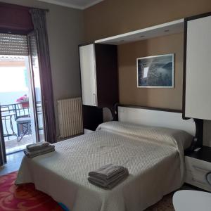 a bedroom with a bed with two towels on it at Casa Blu in Piediluco