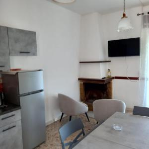 a kitchen with a refrigerator and a table and chairs at Casa Blu in Piediluco +9 photos