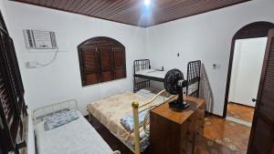 a room with two bunk beds and a fan at Casa em Salinas in Salinópolis