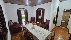 a living room with a table and chairs at Casa em Salinas in Salinópolis