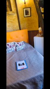 a book sitting on top of a bed at Chambre de la Tour 2 in Milhac +7 photos