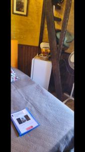 a book is sitting on top of a bed at Chambre de la Tour 2 in Milhac