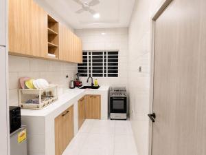 a kitchen with white counters and a stove top oven at Maatambaba Homes in Tamale +5 photos