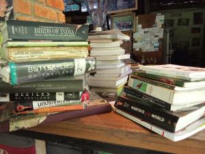 a stack of books sitting on a table at Mr Deang shop Doi Inthanon bird center in Ban Na Yang