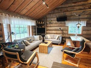 a living room with a couch and a table at Isokelo Log Apartments in Salla