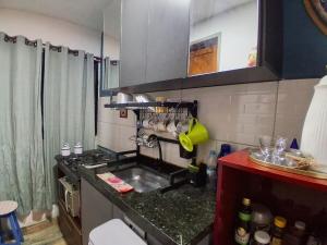 a kitchen with a sink and a counter top at Santa Monica Beach Tiny House in Guarapari +11 photos