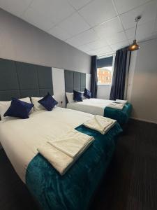 a hotel room with two beds with towels on them at Parkview Residence in Manchester