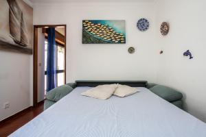 a bedroom with a bed with two pillows on it at Apartamento Vargas in Monte Gordo
