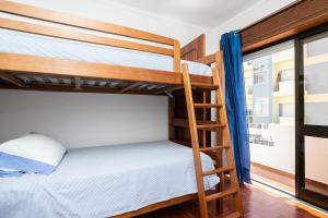 a bunk bed in a room with a ladder at Apartamento Vargas in Monte Gordo +15 photos