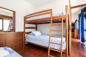 a bedroom with two bunk beds and a desk at Apartamento Vargas in Monte Gordo