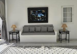 a living room with a couch and two side tables at Menorca Villa Marbella in Son Parc