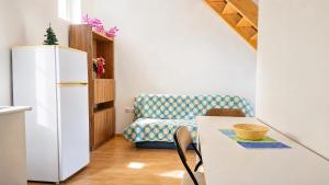 a kitchen with a refrigerator and a table and a chair at DomusCavadas in Porto