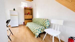 a living room with a couch and a chair at DomusCavadas in Porto +4 photos