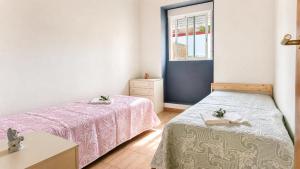 a bedroom with two beds and a window at DomusCavadas in Porto