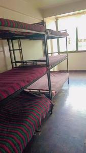 a group of bunk beds sitting in a room at Kioneki Hostel in Nairobi