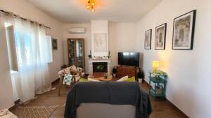a living room with a couch and a tv at Alentejo Colours Cano in Cano