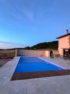 a swimming pool on the roof of a house at La Grange Guesthouse in Beausemblant
