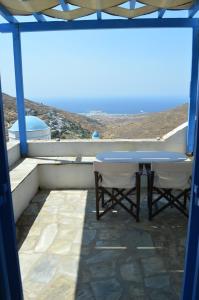 a table and chairs on a balcony with a view at Karyatides Houses in Kariá +1 photo
