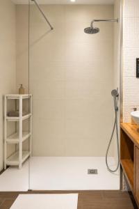 a shower with a glass door in a bathroom at Jack&Lily's in Évora