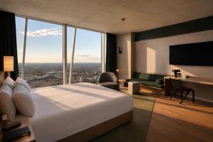 a hotel room with a bed and a desk at Estrel Tower in Berlin