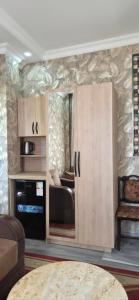 a living room with a cupboard and a couch at Green paradise in Batumi