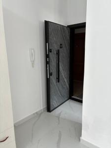 a bathroom with a glass door in a room at Radhima Sun Studio in Vlorë +19 photos