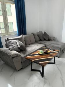 a living room with a couch and a coffee table at Radhima Sun Studio in Vlorë