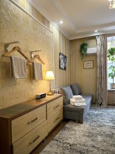 a living room with a couch and a dresser at Hôtel Baldei in Chişinău