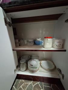a shelf with plates and other dishes in a pantry at Green Paradise in Qax +48 photos