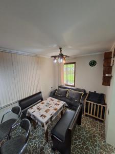 a living room with a couch and a table at Green Paradise in Qax