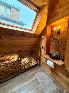 a bathroom with a sink in a wooden cabin at Le Logis du Martray, maison historique in Lamballe Armor