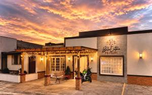 a building with a sunset in the background at Pousada Bello Outono in Canela +27 photos