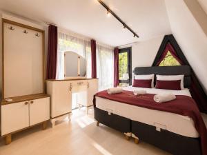 a bedroom with a large bed and a mirror at Gölbaşı Garden Villa in Uzungöl