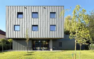 a large building with aagonal facade with a lawn at Casa Brutarului in Timişoara