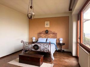 a bedroom with a bed with blue pillows at La Terrazza sul Lago in Panicale